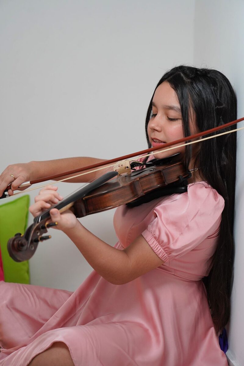 Estudiante de Génesis Academia tocando violín